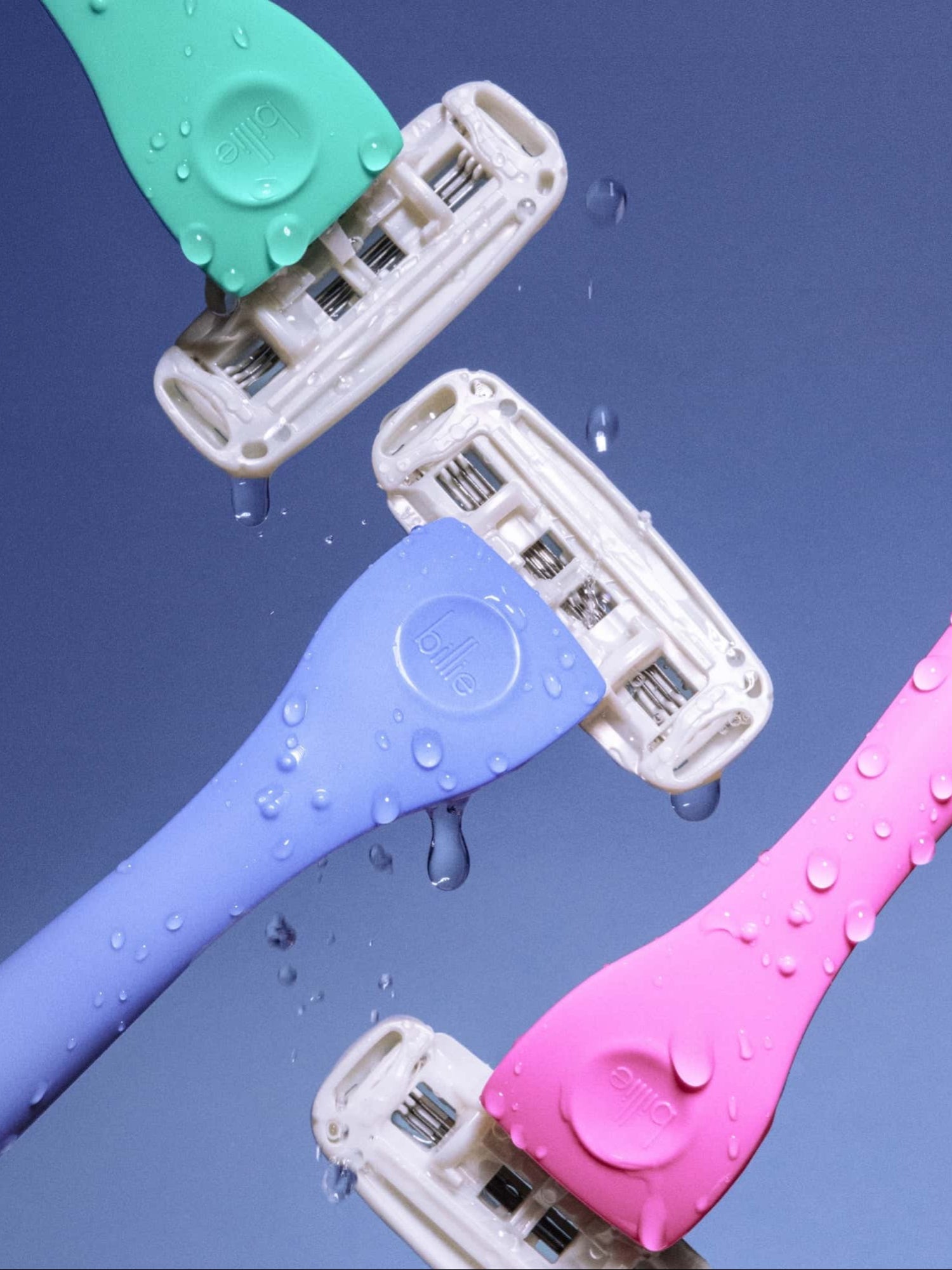 Three dripping razors—green, blue, and pink—float against a blue background, each labeled "billie.