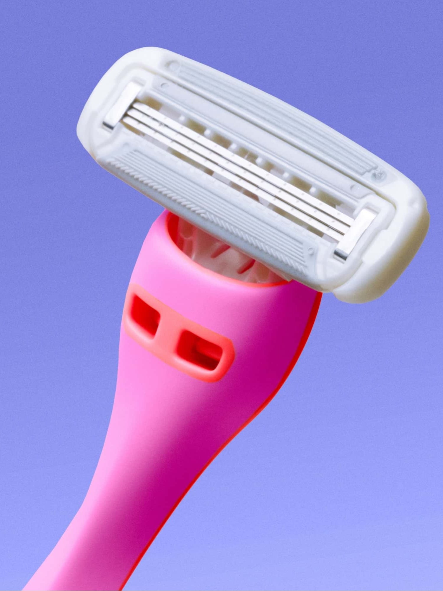A pink razor with a white multi-blade head is angled upward against a smooth, gradient blue background.