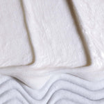 Smooth white shave cream peak highlighting creamy texture and elegant swirl.
