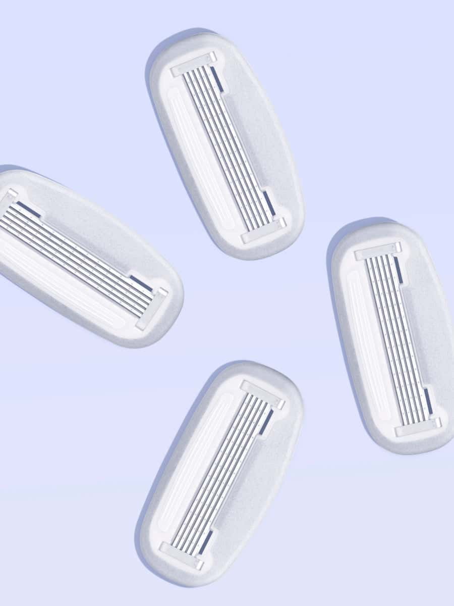 Four angled razor blade refills on light blue background, showing multiple blades—symbolising refill options.